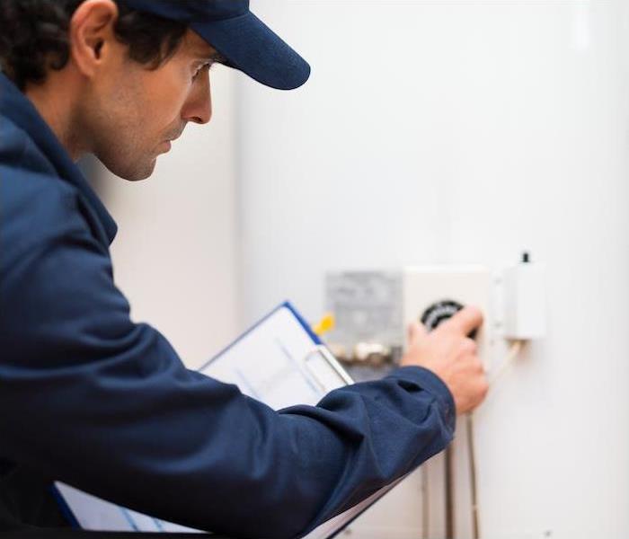 man inspecting water controls