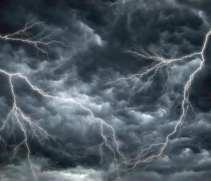 Lightning strikes in a dark, stormy sky