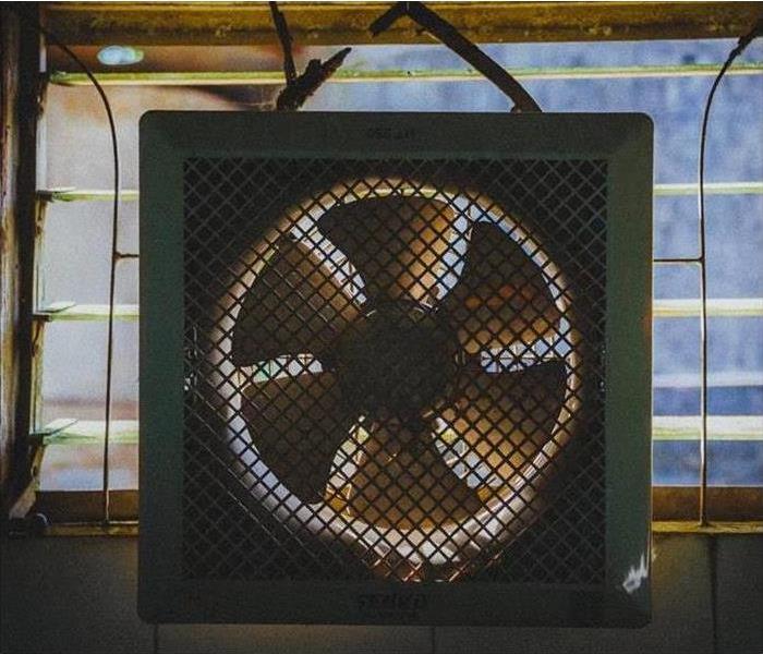 white fan on a desk