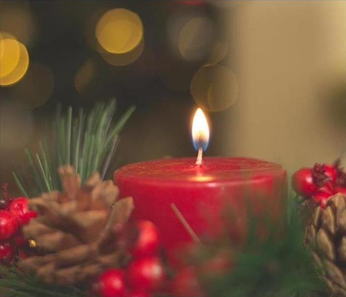 red christmas candle with holly