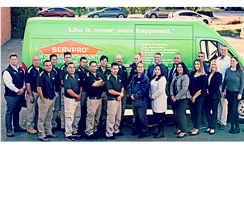 Photo of the entire team in front of our SERVPRO van. 